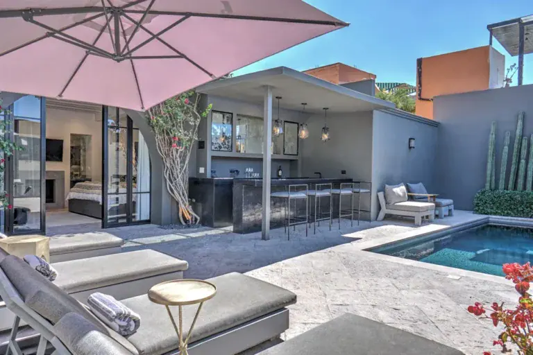 Casa Arcadia, courtyard pool with lounge chairs, a pink umbrella and a covered outdoor kitchen, San Miguel de Allende