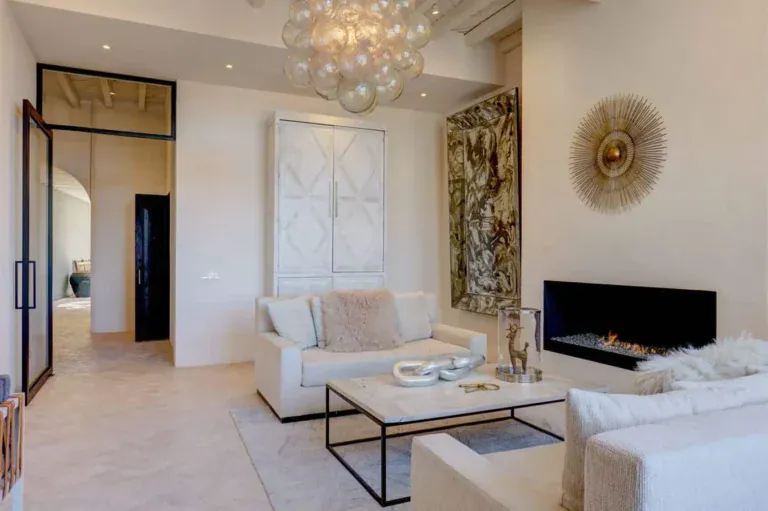 Casa Arcadia, living room with a linear fireplace, cream sofas and a bubble chandelier, San Miguel de Allende