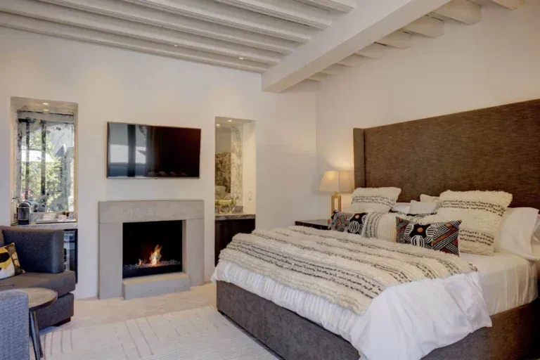 Casa Arcadia, bedroom with a fireplace, a woven throw and a padded headboard, San Miguel de Allende