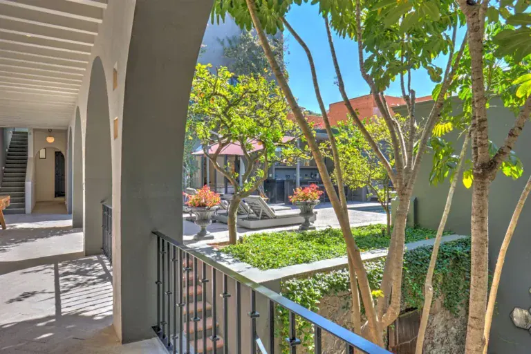 Casa Arcadia, view from an arched walkway over a garden courtyard, San Miguel de Allende