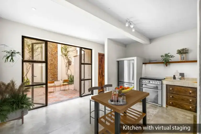 Casa Beatrice, kitchen with a wood island and stools, a plant and a steel-framed glass wall, labeled as virtually staged, San Miguel de Allende
