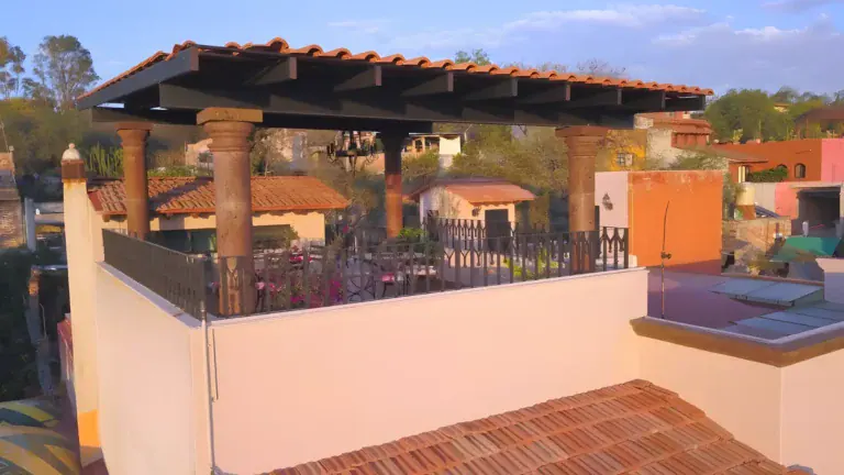 Casa Bellavista, rooftop terrace with a tile-roofed pergola, stone columns and views over the town, San Miguel de Allende