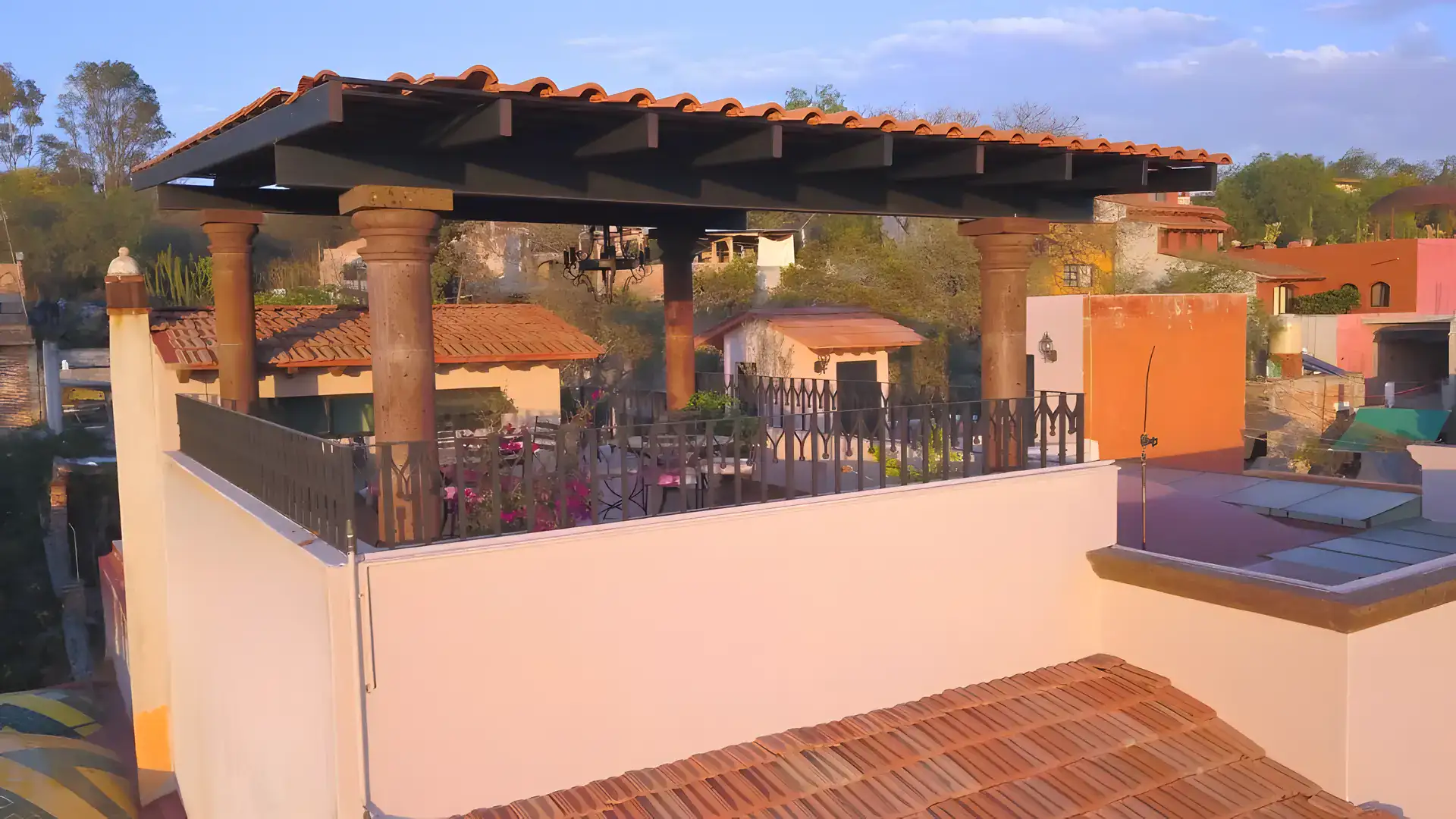 Casa Bellavista, rooftop terrace with a tile-roofed pergola, stone columns and views over the town, San Miguel de Allende