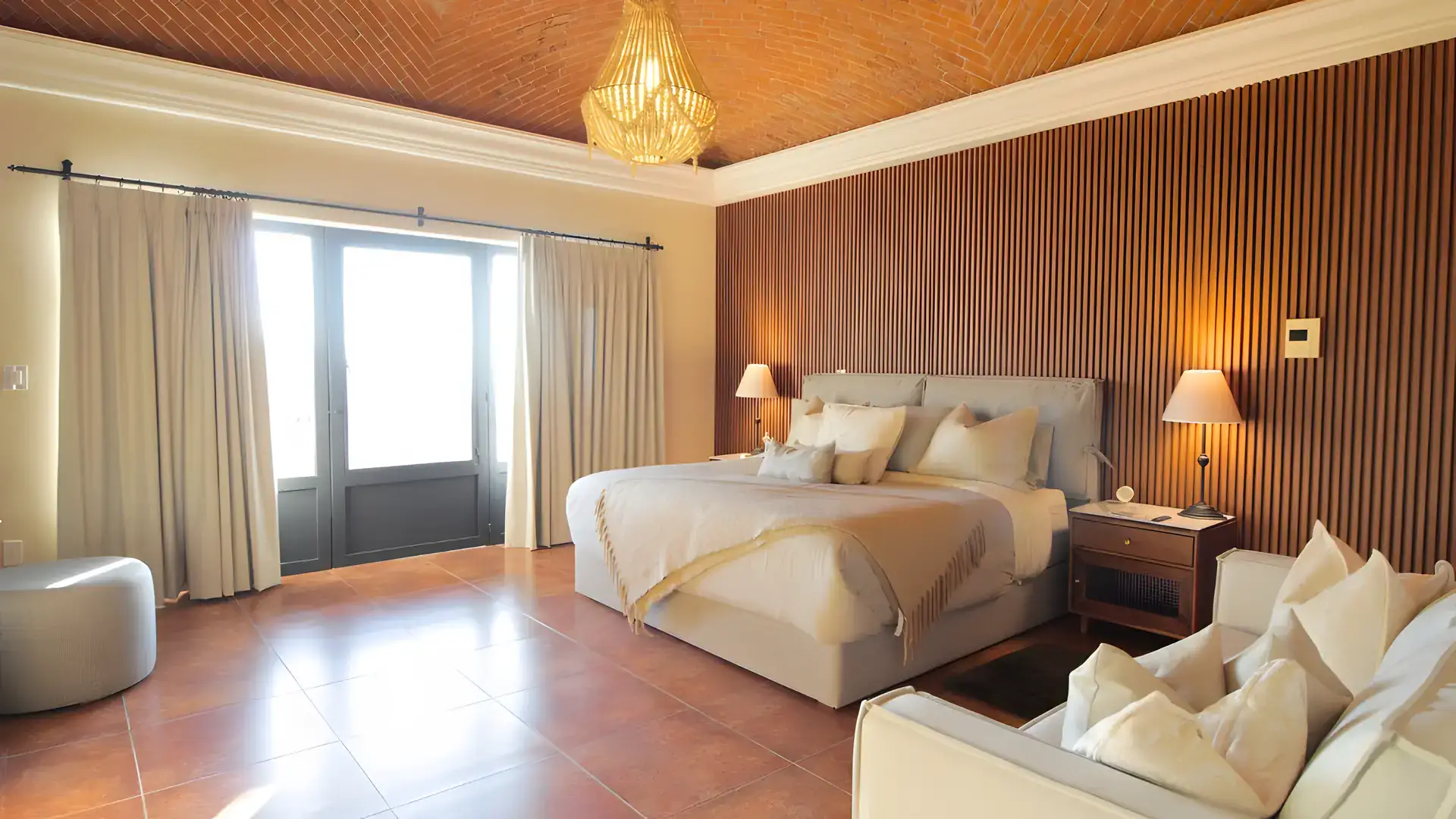 Casa Bellavista, bedroom with glass doors to a balcony, a white sofa and a beaded chandelier, San Miguel de Allende