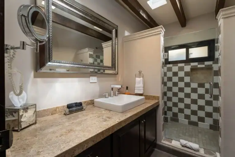 Casa Biblioteca, bathroom with a granite vanity, vessel sink and a checkerboard tile shower, San Miguel de Allende