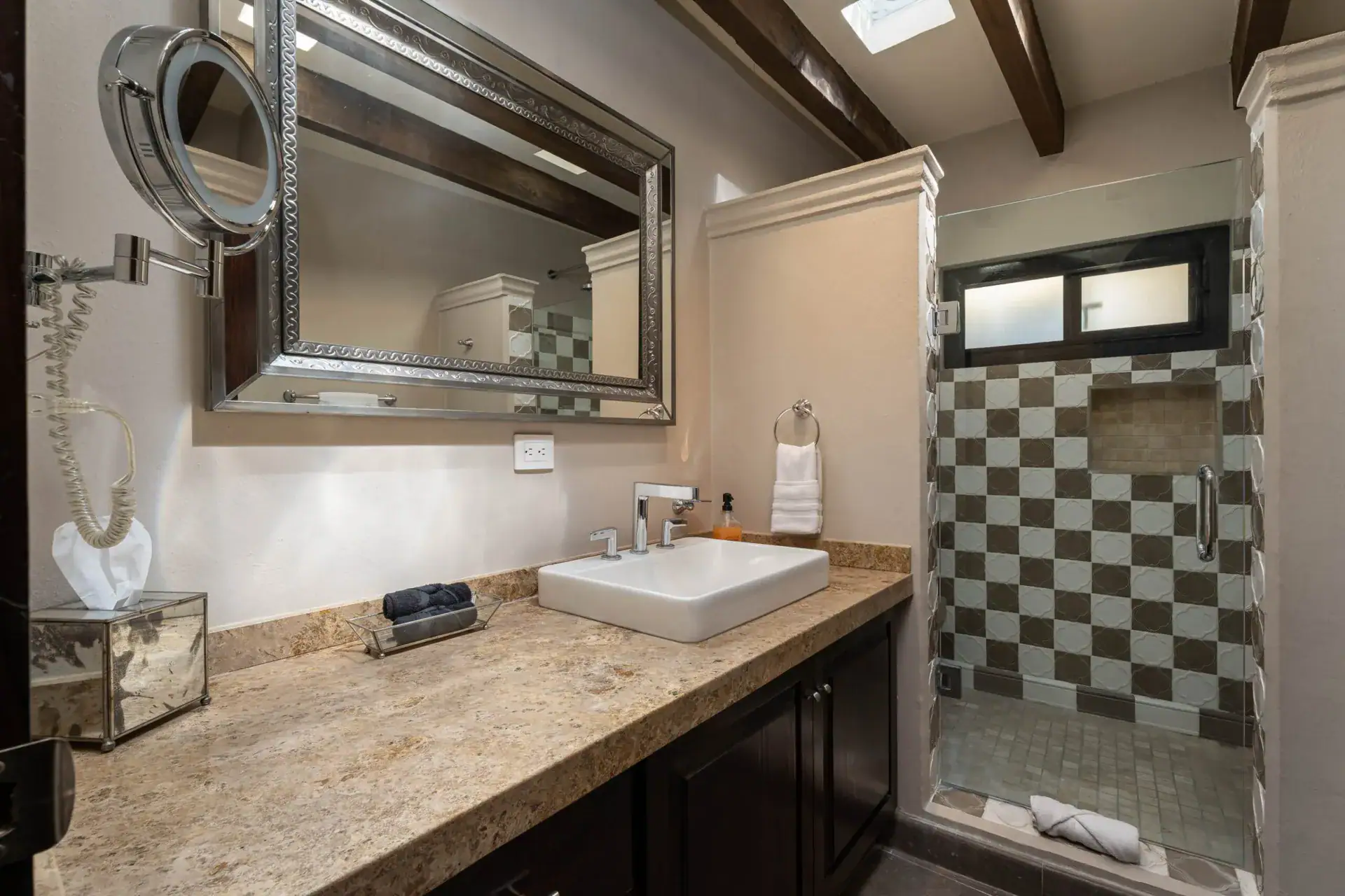 Casa Biblioteca, bathroom with a granite vanity, vessel sink and a checkerboard tile shower, San Miguel de Allende