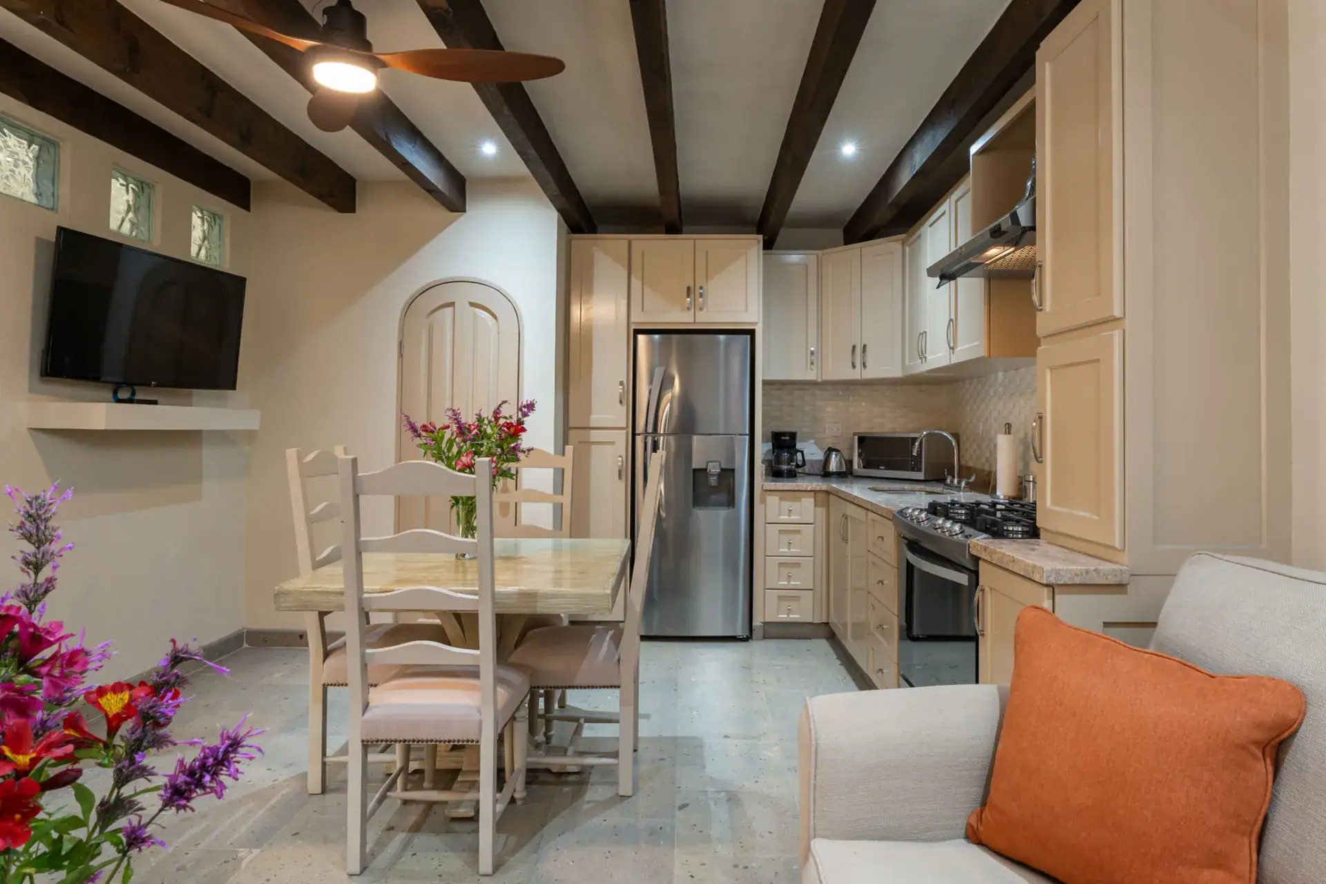 Casa Biblioteca, dining table and living area with a television and open kitchen, San Miguel de Allende