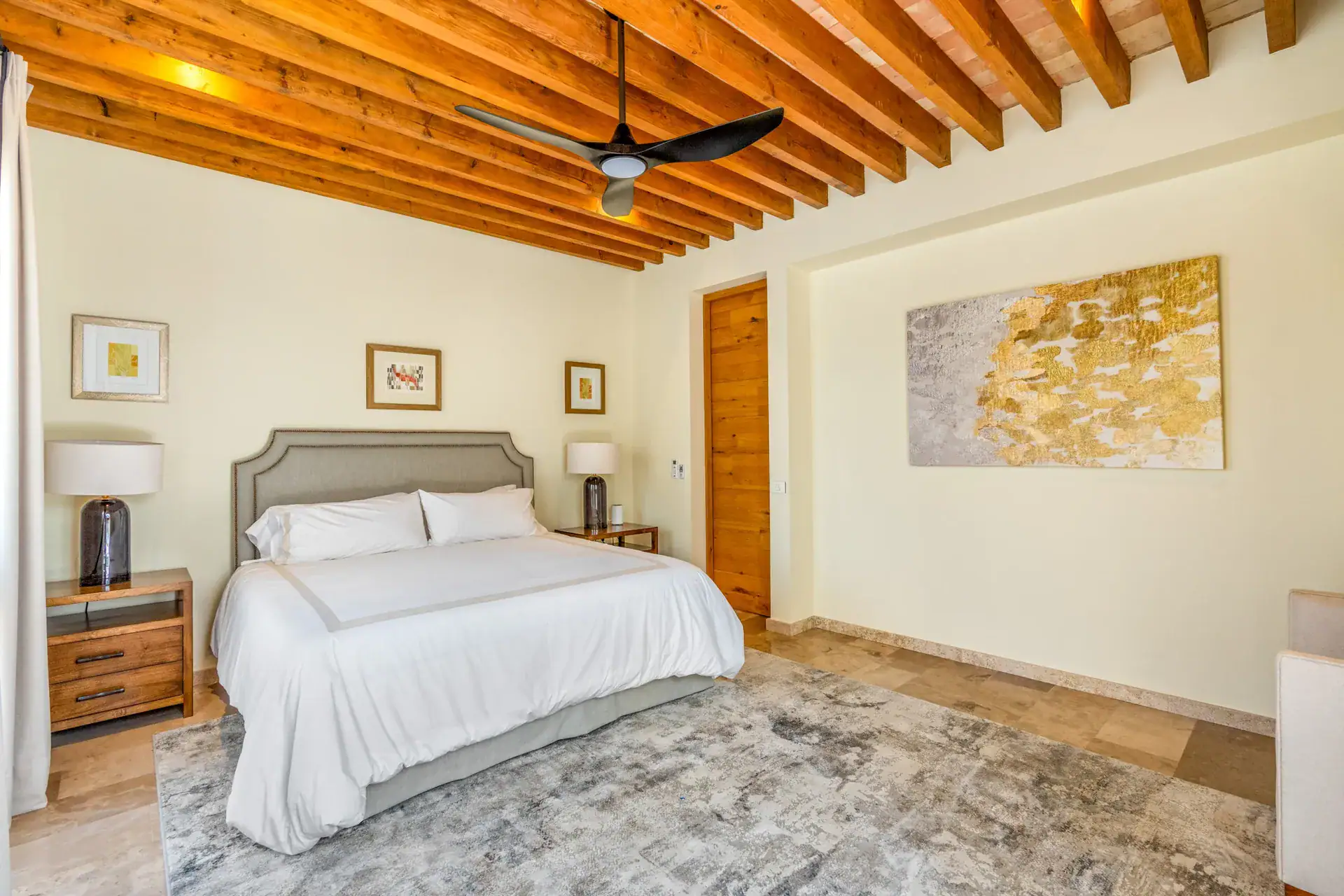 Casa Buenos Tiempos, bedroom with a king bed, a ceiling fan and a wood door, San Miguel de Allende