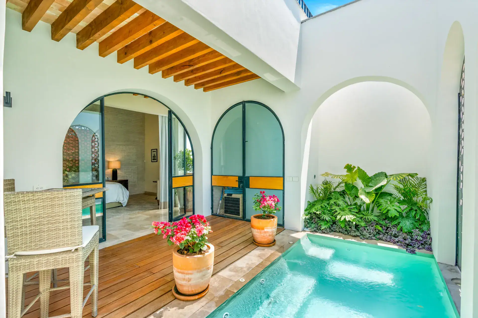 Casa Buenos Tiempos, private plunge pool patio with a wood deck, bougainvillea and arched doors, San Miguel de Allende