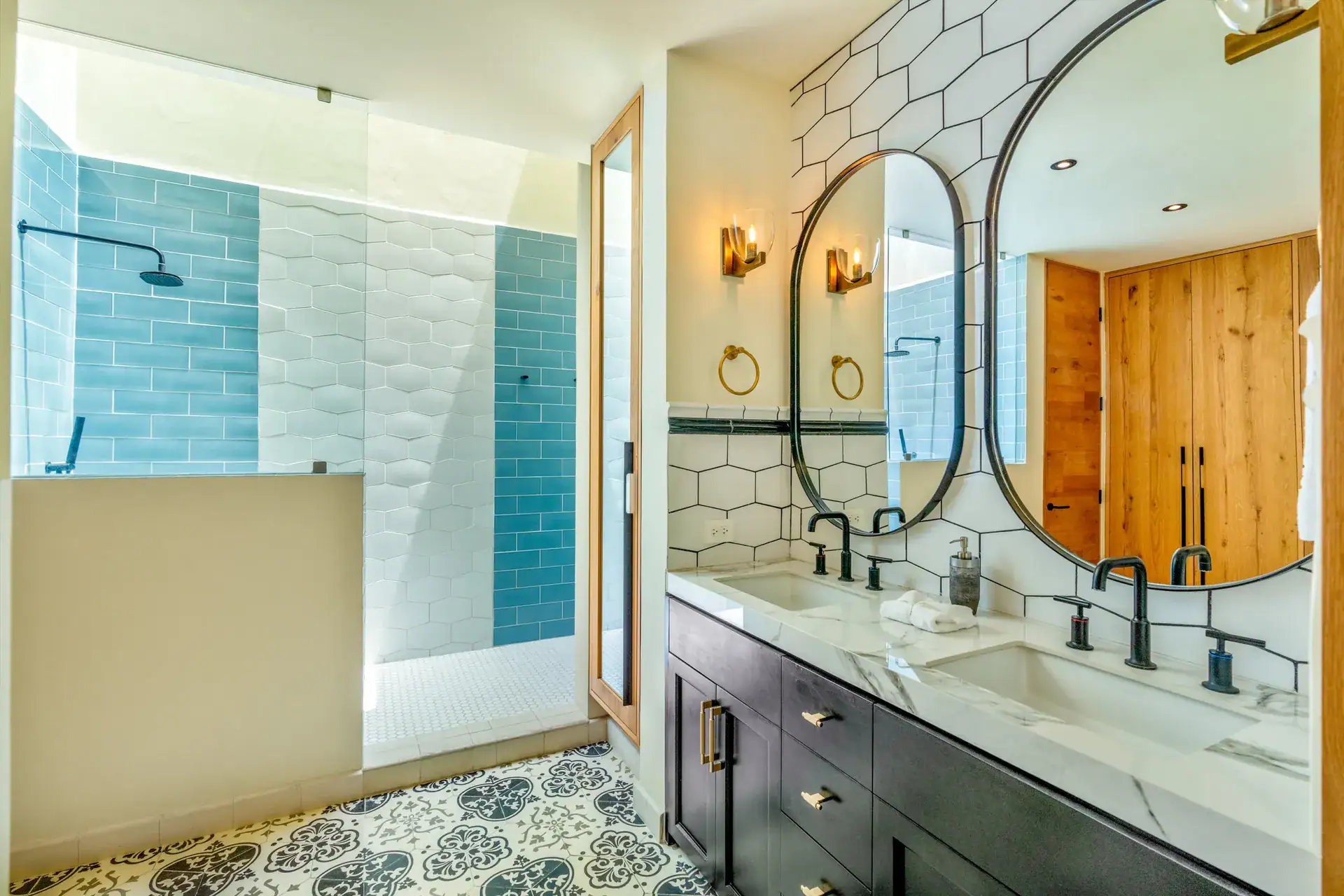 Casa Buenos Tiempos, bathroom with a double vanity, oval mirrors, hexagon tile and a blue tile shower, San Miguel de Allende