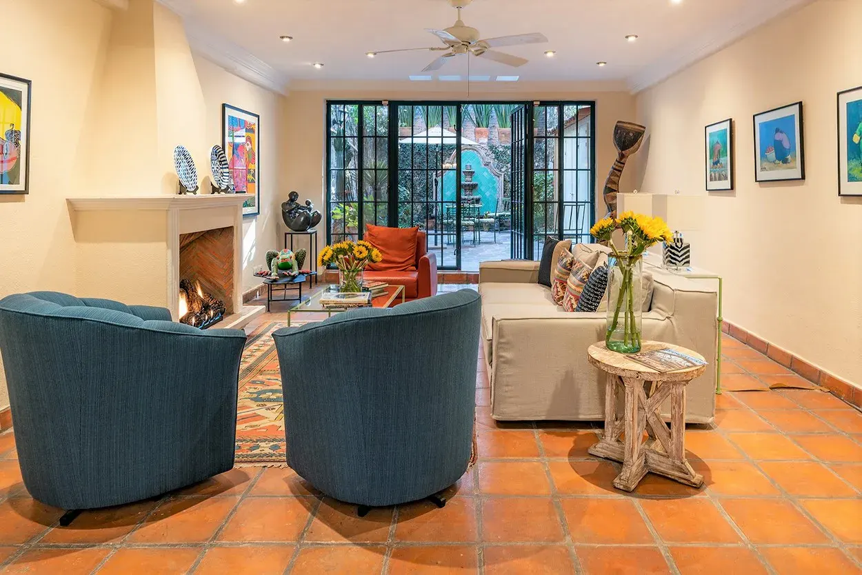 Casa Caminando, sitting room with a fireplace and large steel-framed windows, San Miguel de Allende