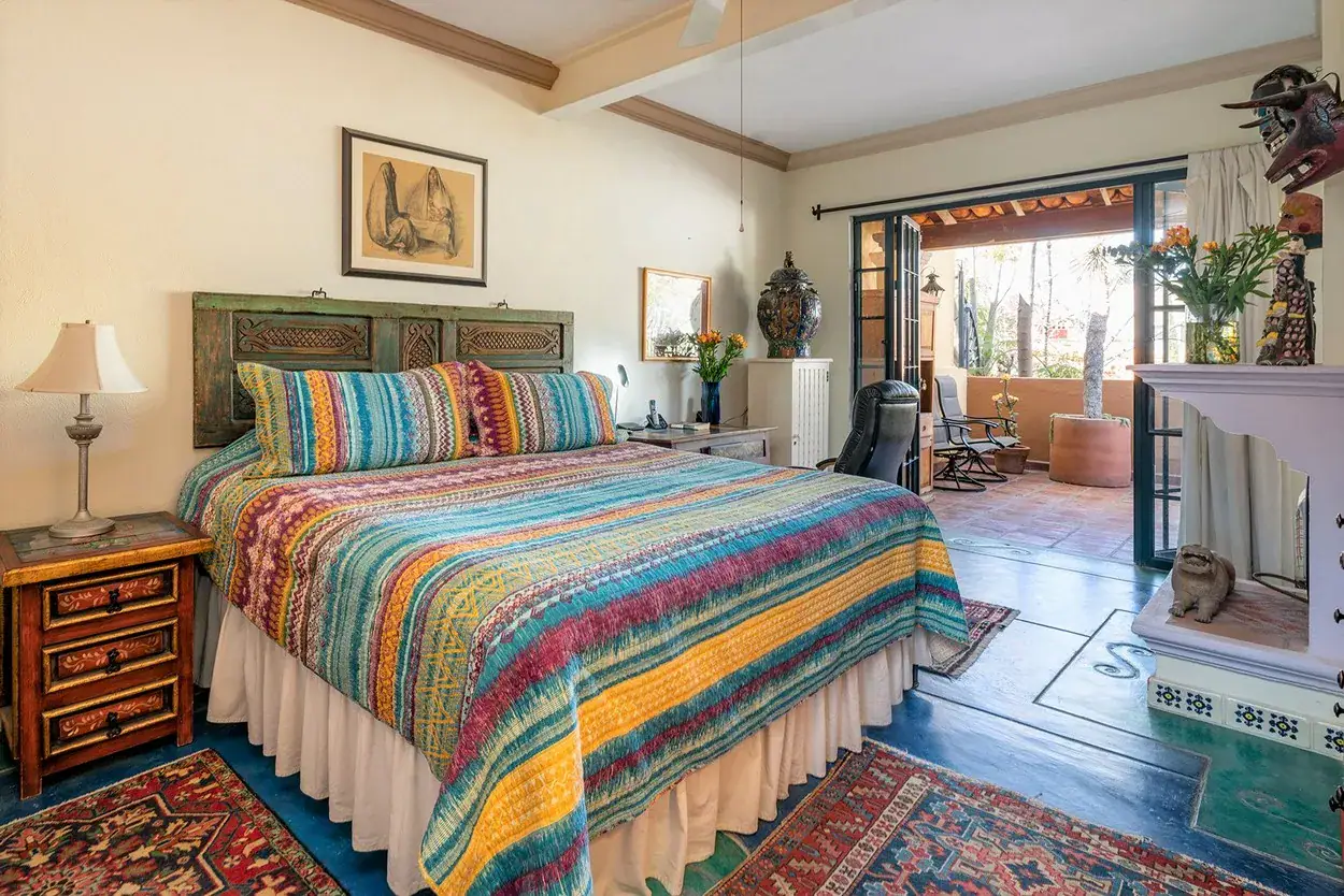 Casa Caminando, bedroom with a striped quilt and doors to a terrace, San Miguel de Allende