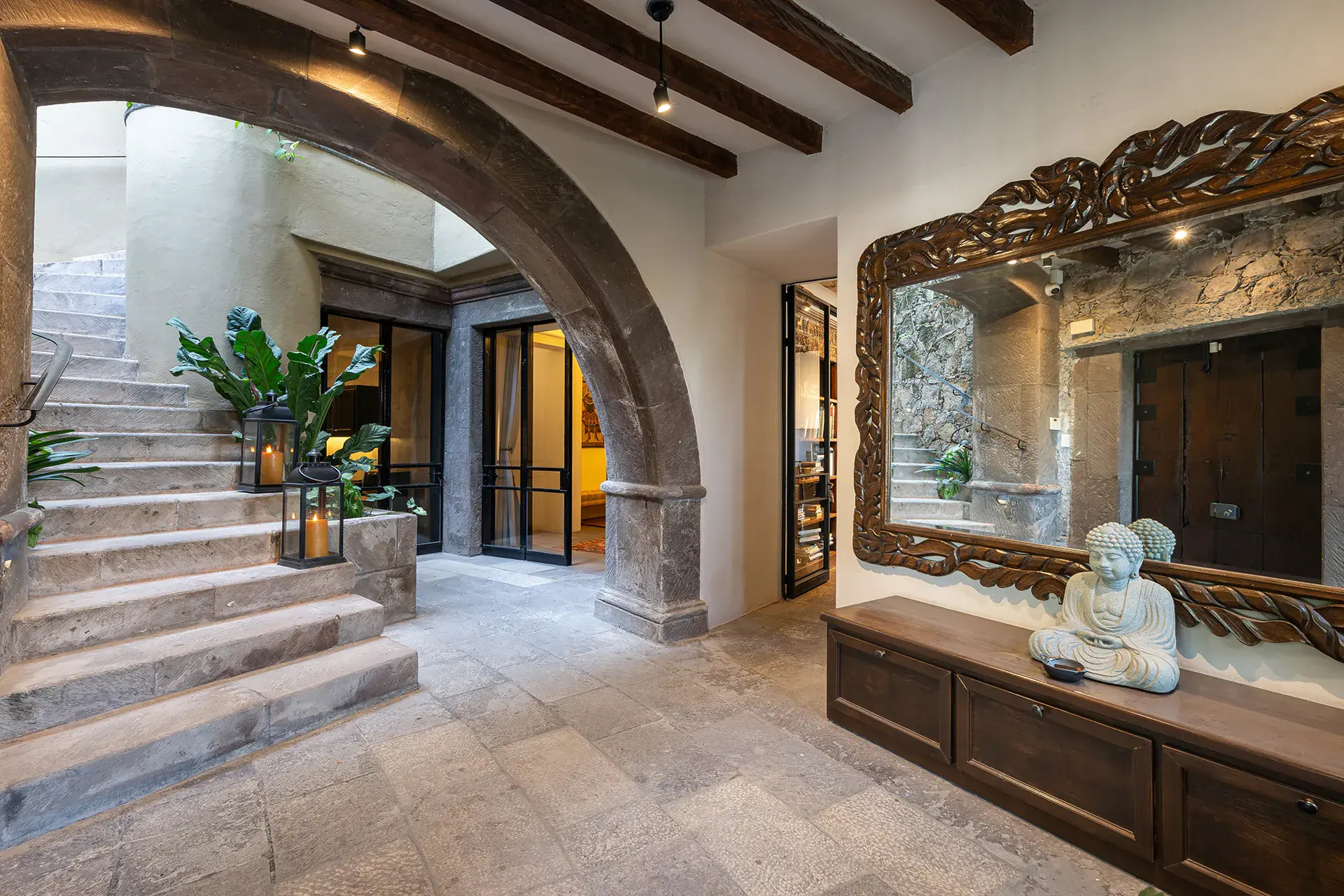 Casa Cañadita, stone arch entry with a staircase and a carved mirror, San Miguel de Allende