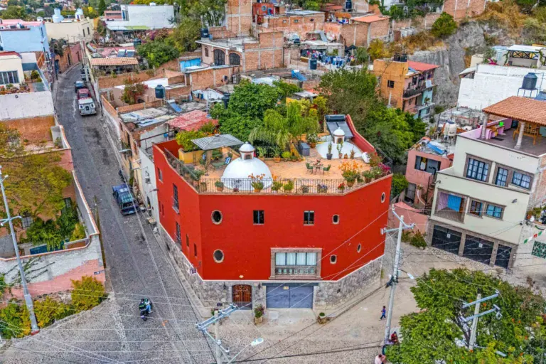 Casa Caracol Rojo, aerial view of the red house with a rooftop garden and a white dome, San Miguel de Allende