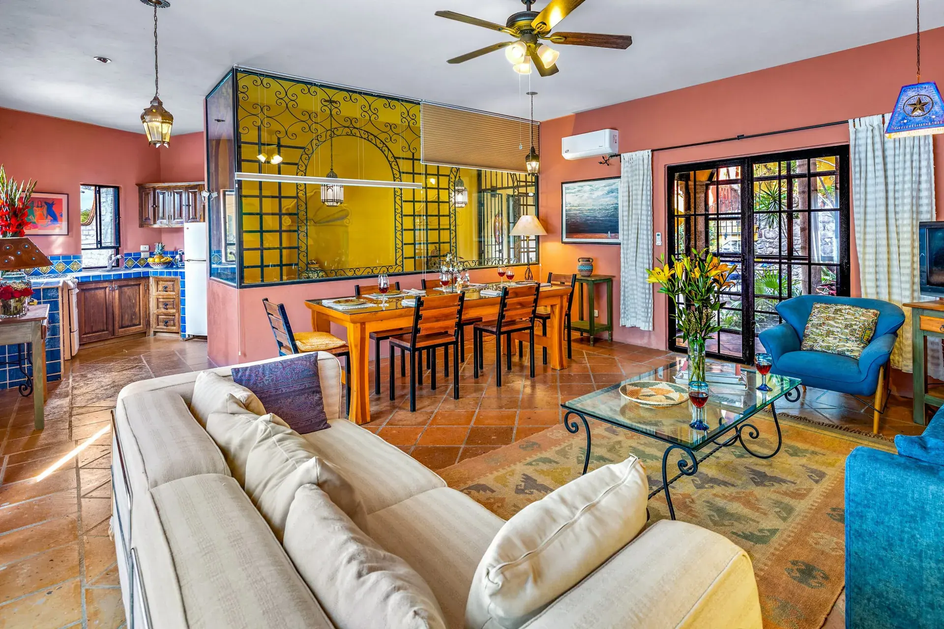 Casa Caracol Rojo, living and dining area with a long wood table and a white sofa, San Miguel de Allende