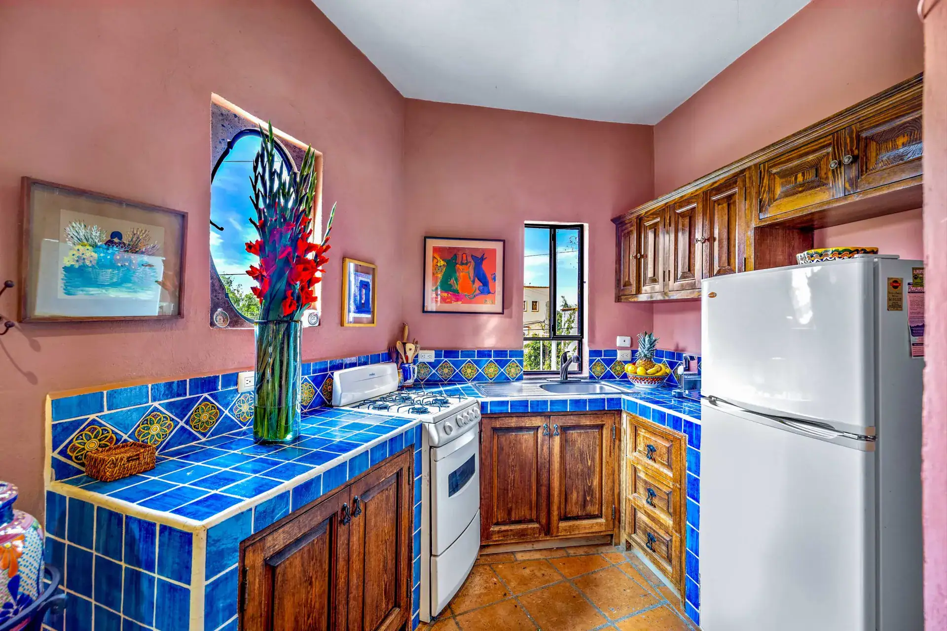Casa Caracol Rojo, kitchen with blue tile counters and a white refrigerator, San Miguel de Allende
