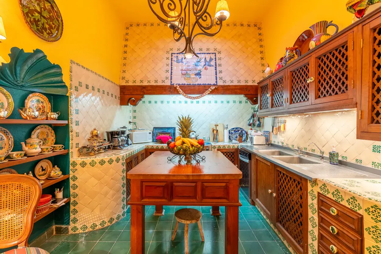 Casa Carolina, kitchen with talavera tile, wood cabinets and a center island, San Miguel de Allende