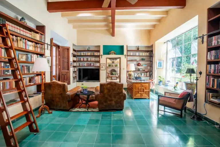 Casa Carolina, library with floor-to-ceiling bookshelves and leather chairs, San Miguel de Allende