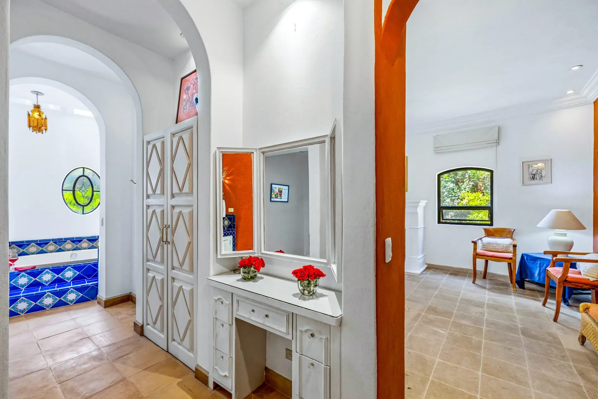 Casa Cascada, dressing area with white doors, a vanity with mirror and a view to the bedroom, San Miguel de Allende