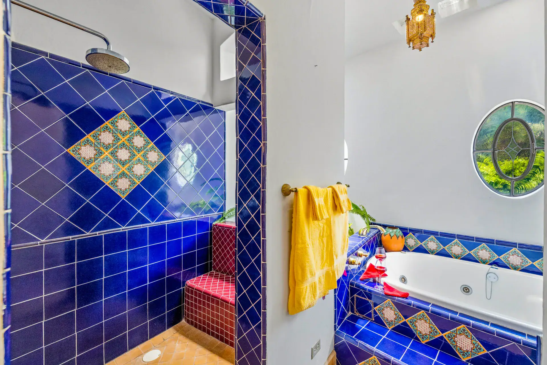 Casa Cascada, blue tile shower with a rain head, a whirlpool tub and a round stained glass window, San Miguel de Allende