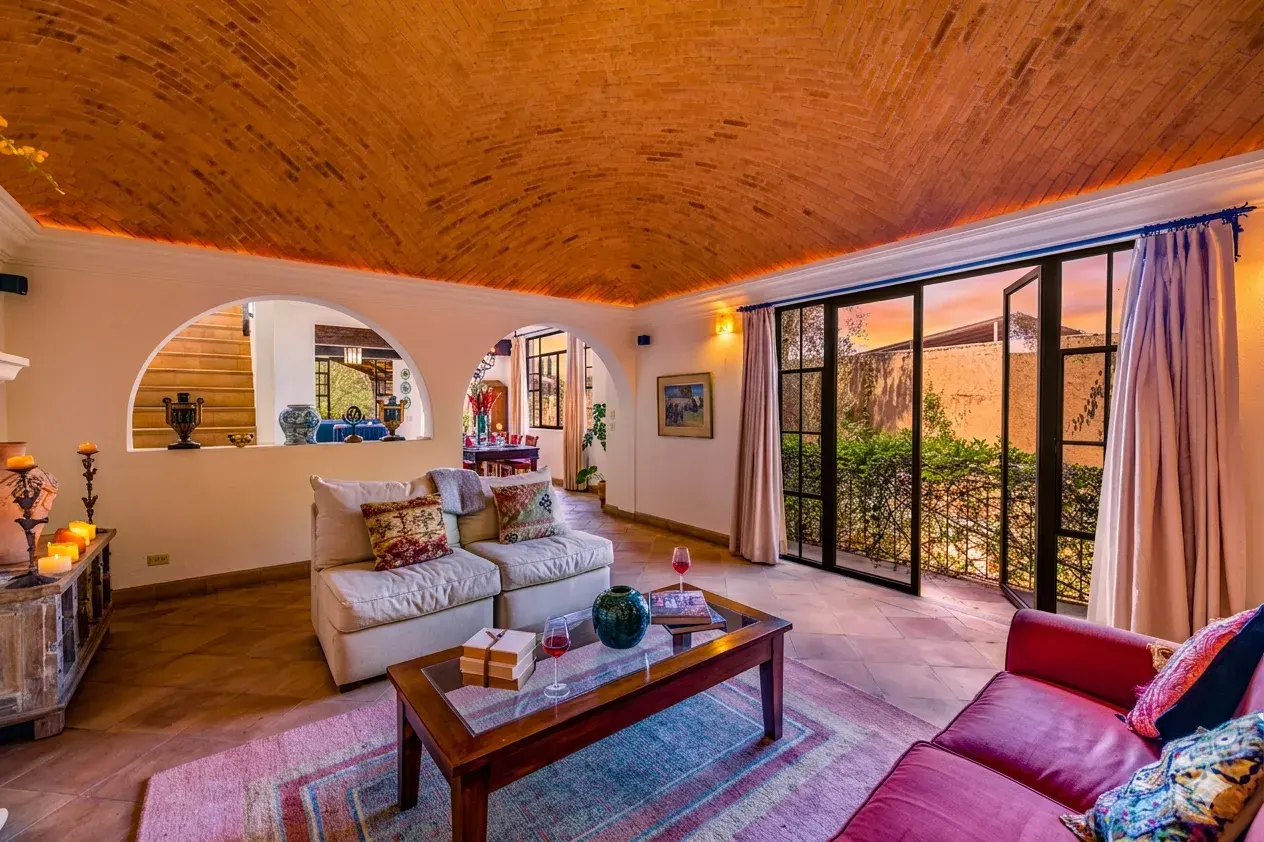 Casa Cascada, living room with glass doors open to a terrace and arched wall niches, San Miguel de Allende