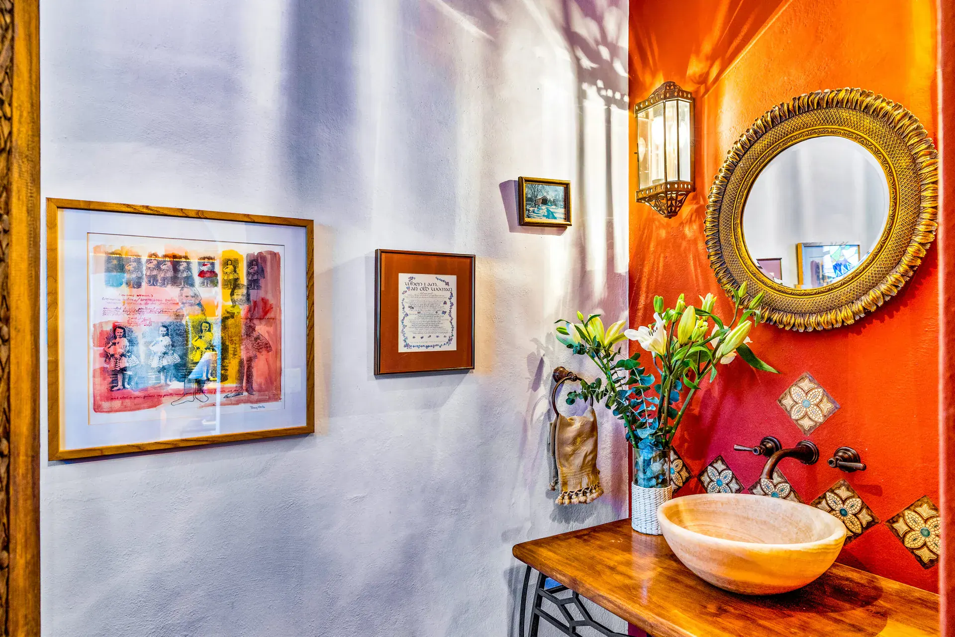 Casa Cascada, powder room with an orange wall, a round gold mirror, a stone vessel sink and Talavera tile, San Miguel de Allende