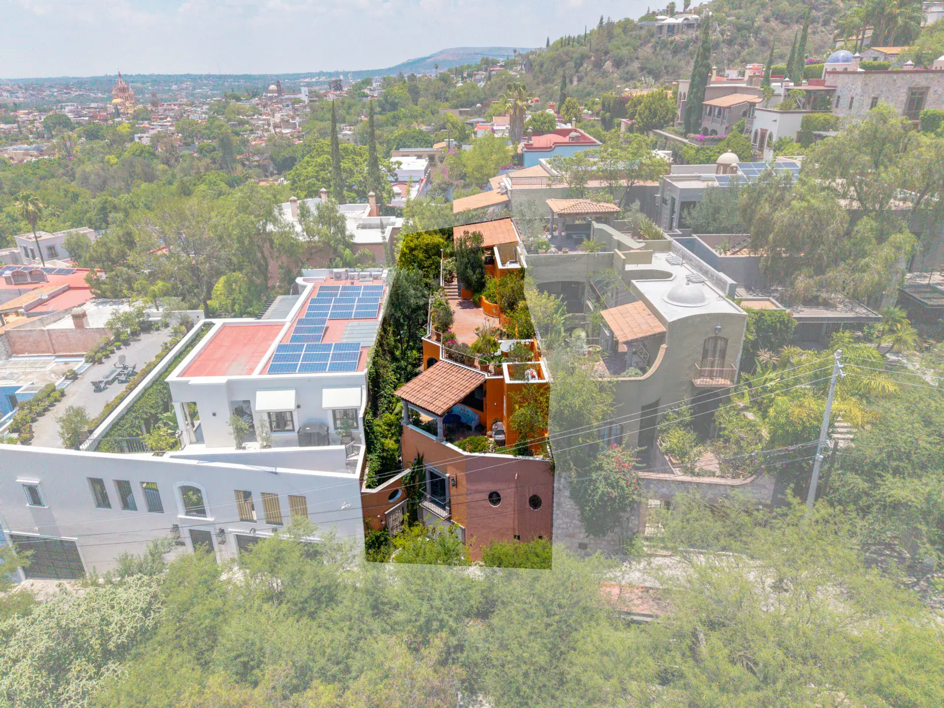 Casa Cascada, aerial view of the terraced house among homes on the hillside, San Miguel de Allende