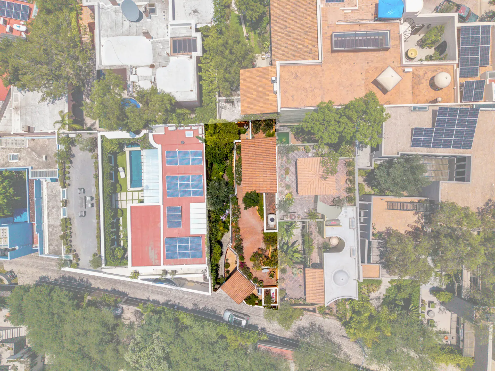 Casa Cascada, overhead drone view of the property and neighboring rooftops with solar panels, San Miguel de Allende