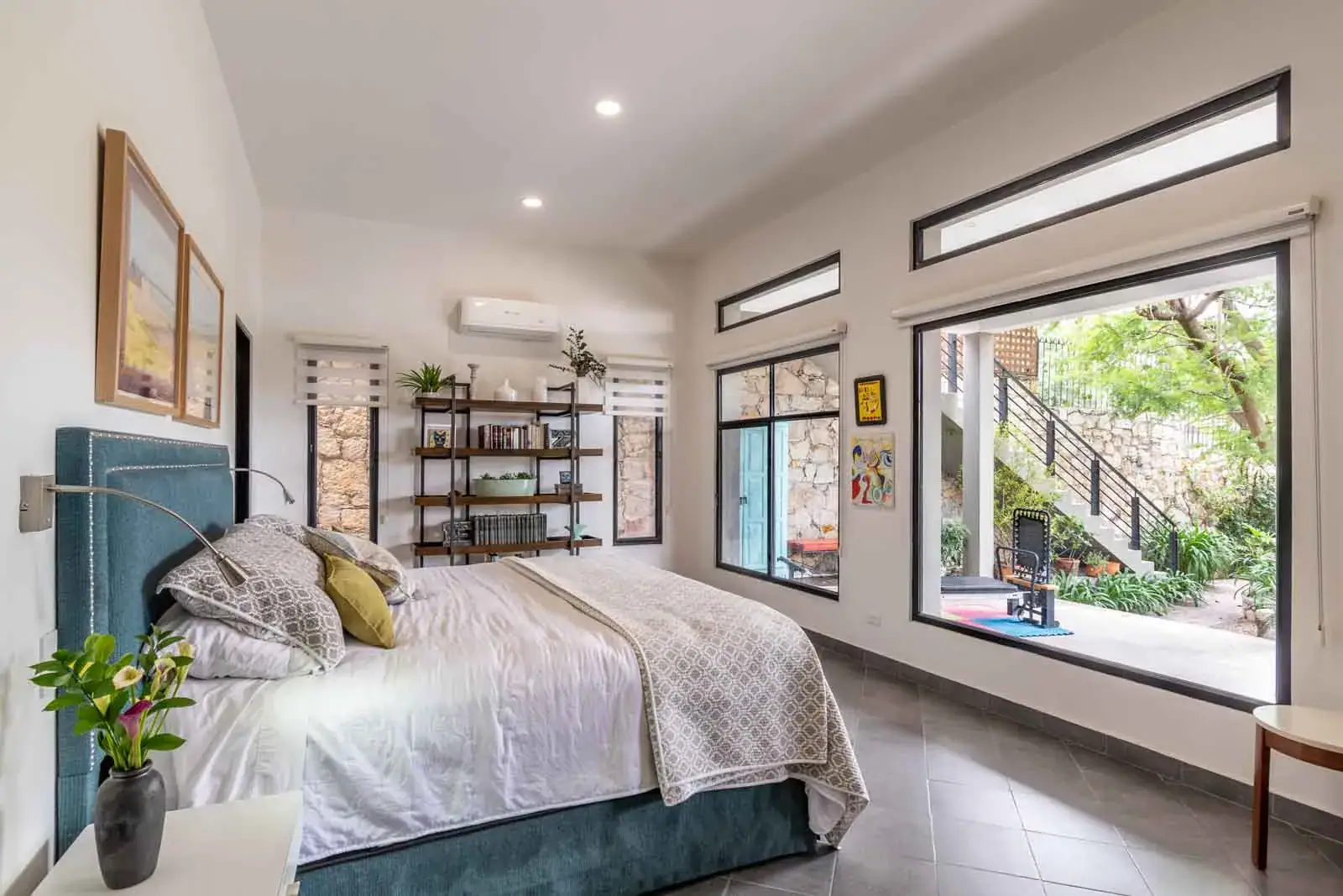 Casa Cielo Abierto, bedroom with a teal headboard, a large picture window and a view to the garden steps, San Miguel de Allende