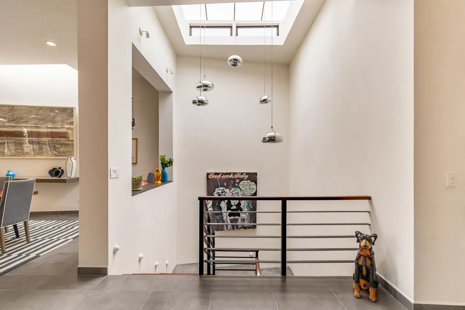 Casa Cielo Abierto, stair landing with a skylight, an iron railing and a small dog statue, San Miguel de Allende