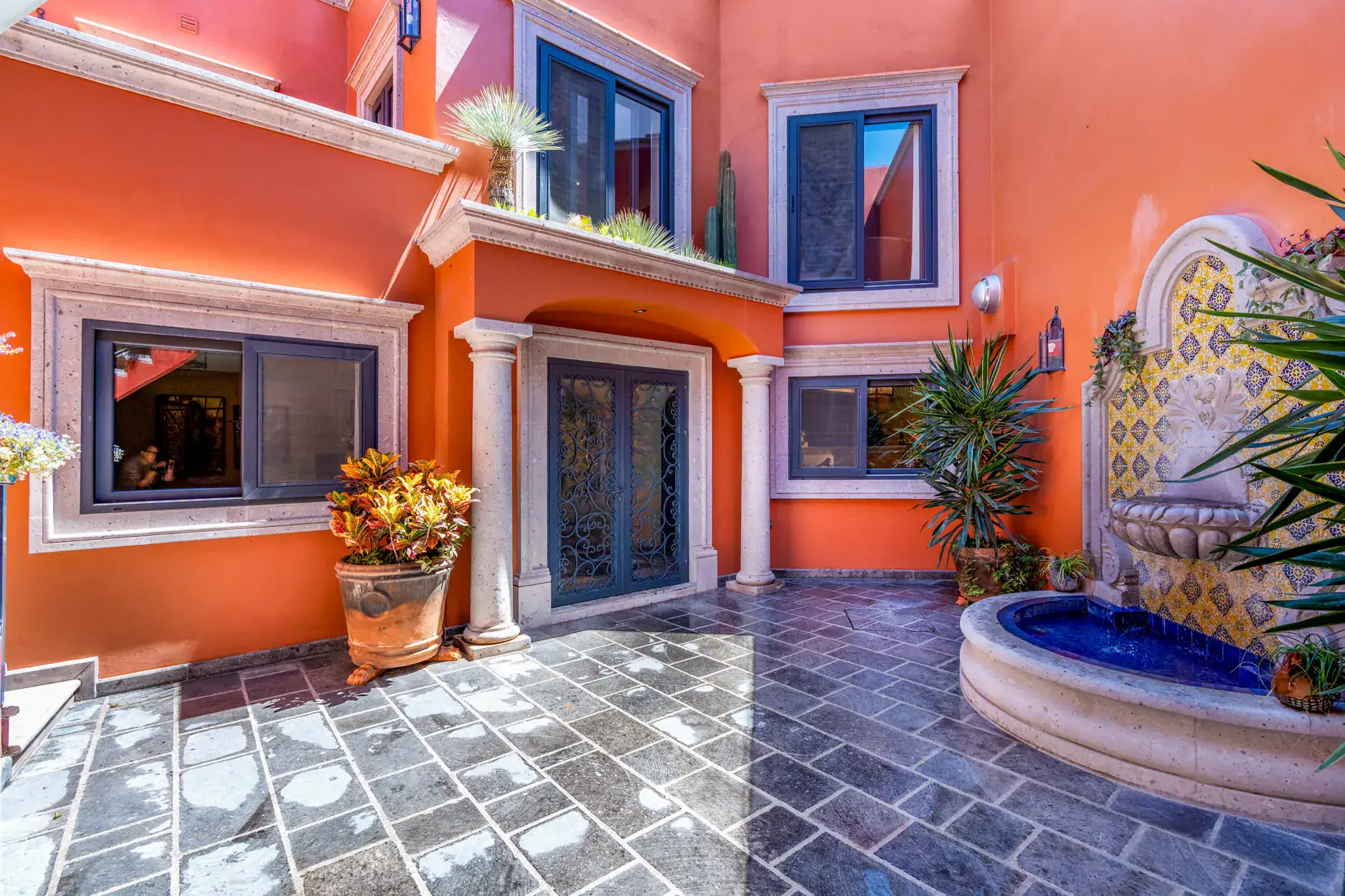 Casa Cleo Petra, entry courtyard with a tiled wall fountain and a slate floor, San Miguel de Allende