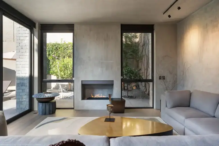 Casa Core, living room with a linear fireplace, gray sofas and glass doors to the garden, San Miguel de Allende