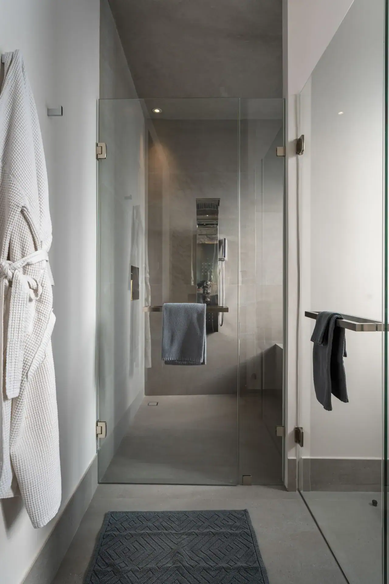 Casa Core, glass-enclosed shower with a white robe hanging beside it, San Miguel de Allende