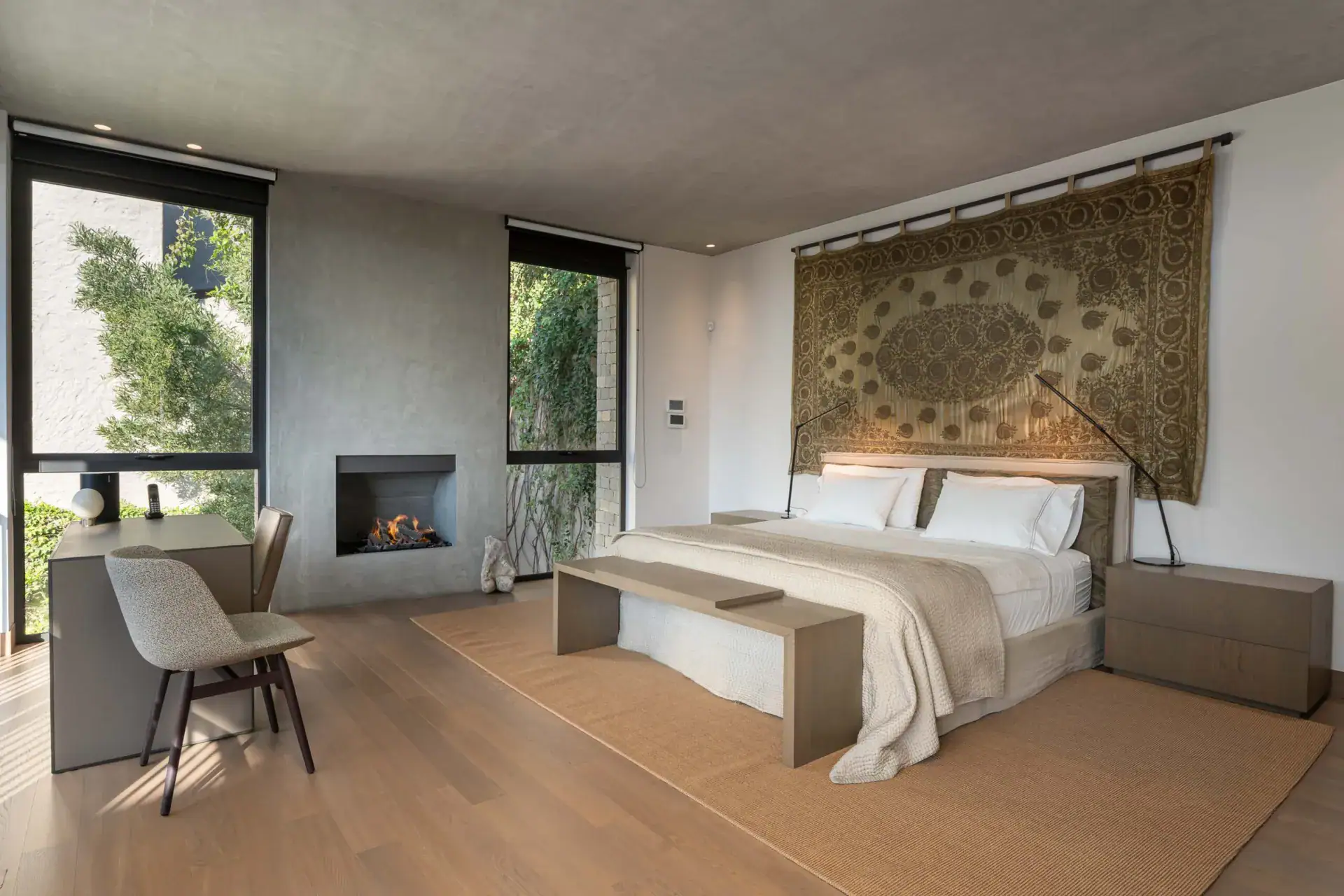 Casa Core, bedroom with a woven wall tapestry, desk and fireplace, San Miguel de Allende