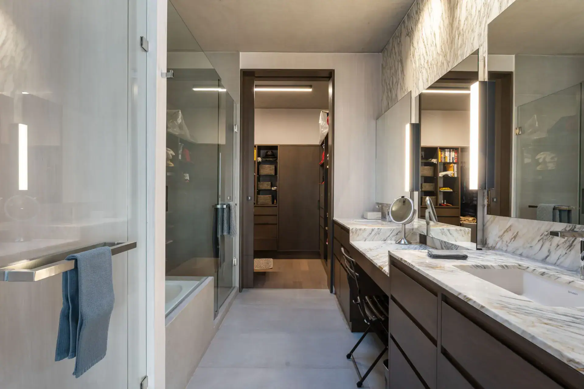 Casa Core, bathroom with a marble double vanity, soaking tub and a walk-in closet beyond, San Miguel de Allende