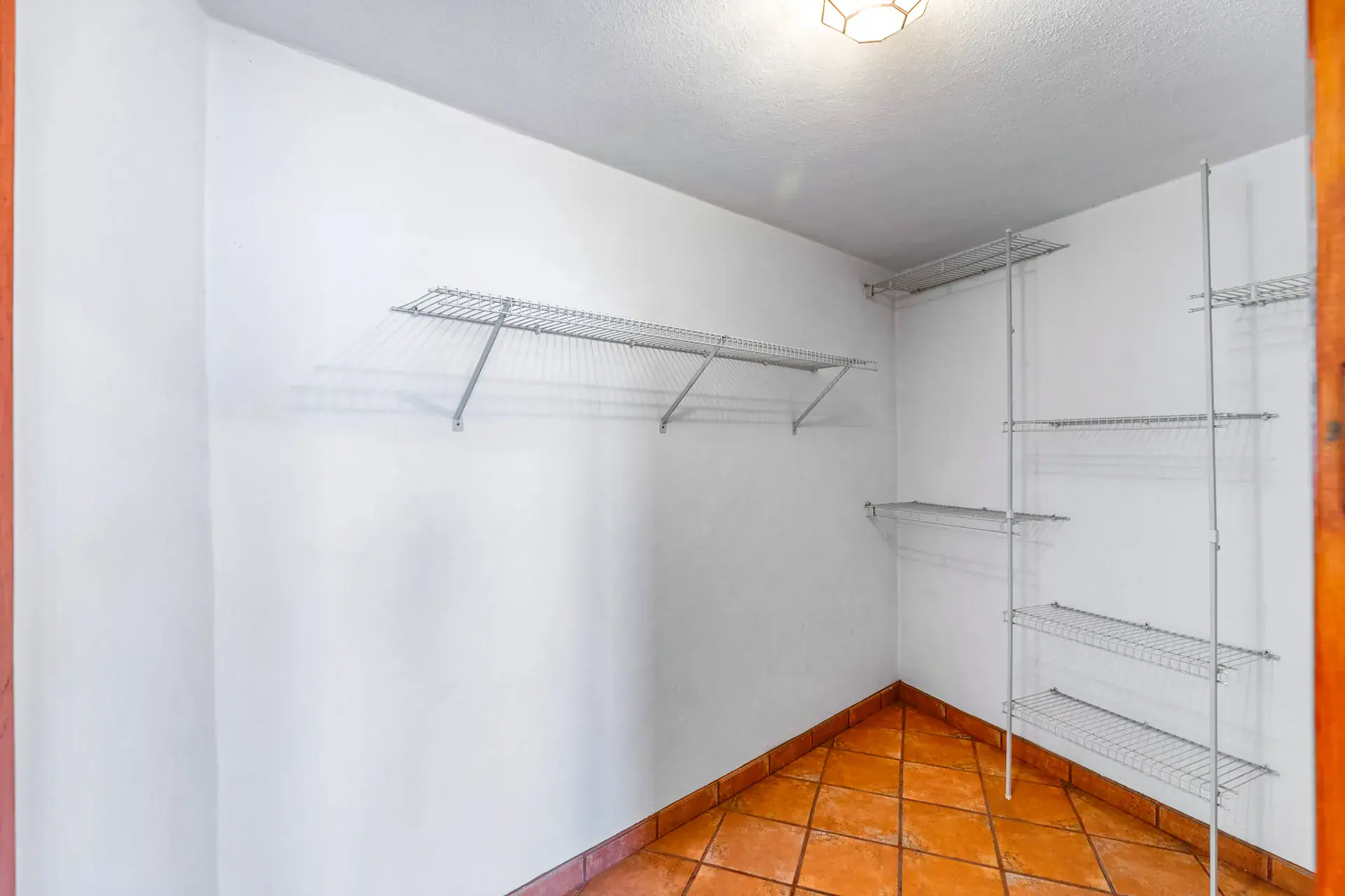 Casa Cul-De-Sac Armonia, empty walk-in closet with white wire shelving, San Miguel de Allende
