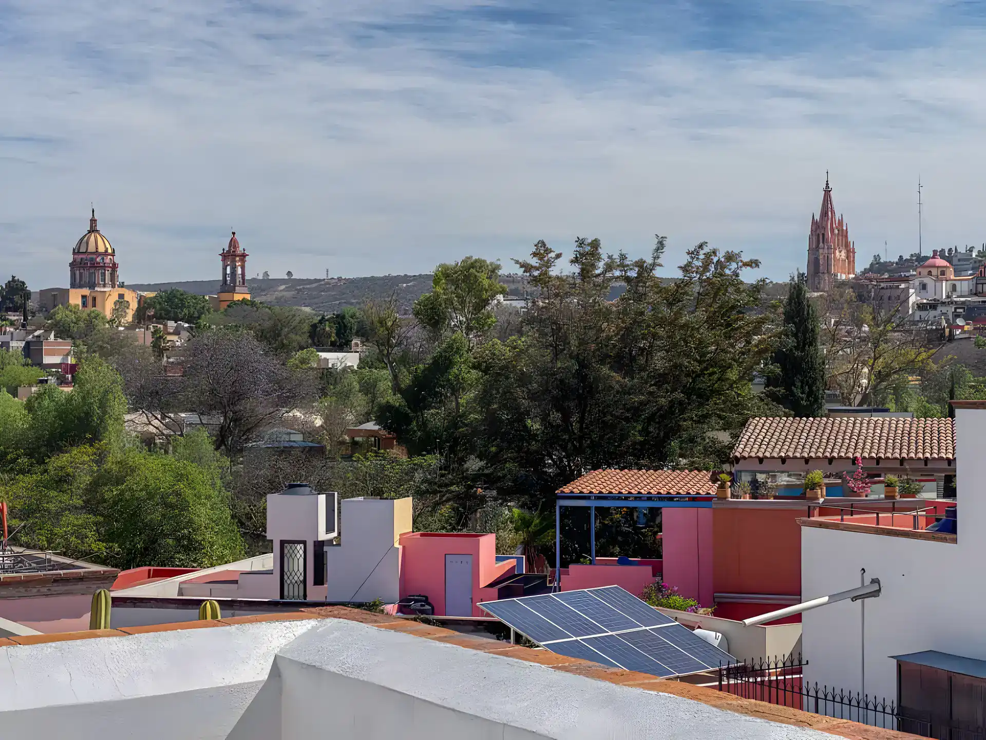 Casa de la Gracia, view over rooftops to the Parroquia and the church domes from the roof, San Miguel de Allende