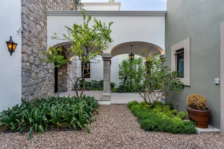 Casa de la Leona, stone and stucco courtyard with arches, citrus trees and a gravel garden, San Miguel de Allende