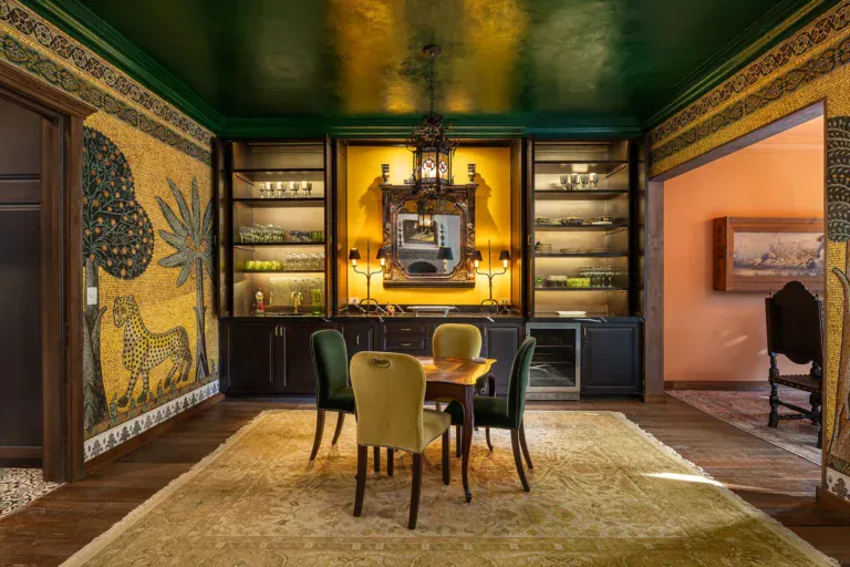 Casa de la Leona, dining room with gold painted murals, built-in shelves and a green ceiling, San Miguel de Allende