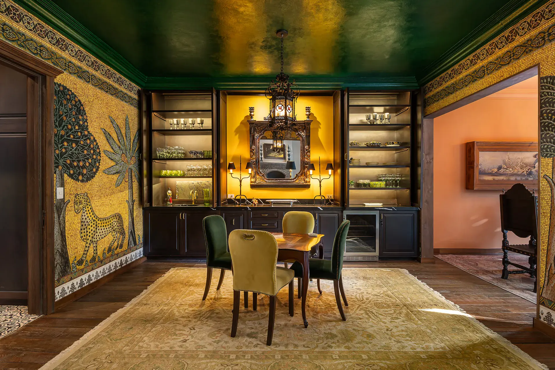 Casa de la Leona, dining room with gold painted murals, built-in shelves and a green ceiling, San Miguel de Allende