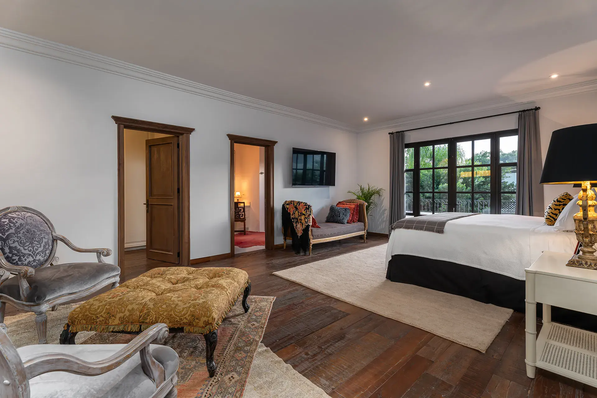 Casa de la Leona, primary bedroom with a sitting area and large windows, San Miguel de Allende