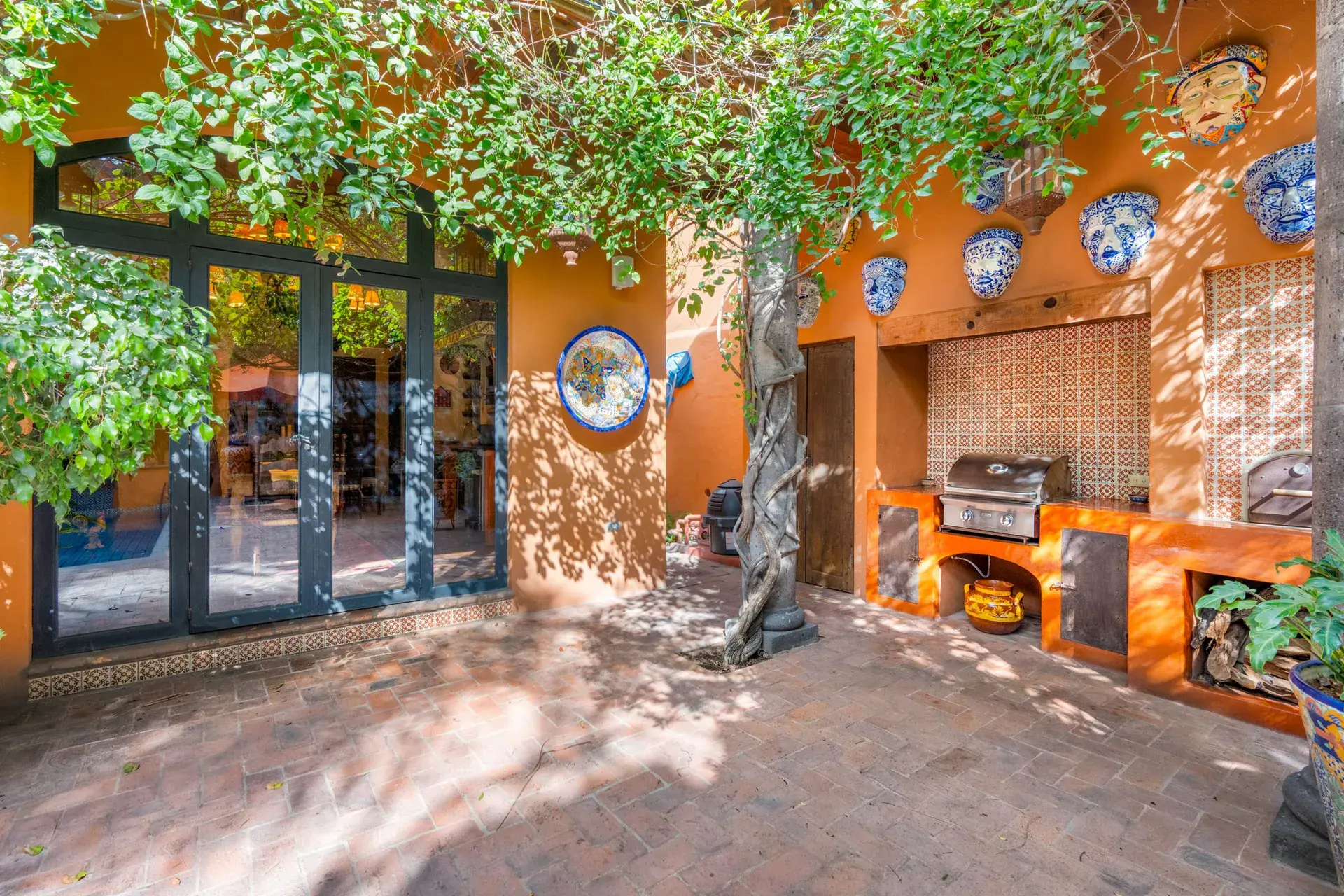 Casa de la Suerte, courtyard outdoor kitchen under a vine-covered arbor, San Miguel de Allende