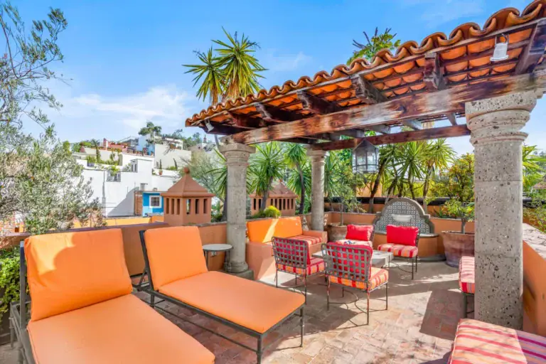 Casa de la Suerte, rooftop terrace with a tile pergola, lounge chairs and a fire pit, San Miguel de Allende