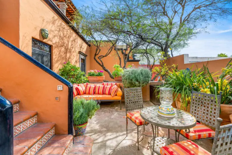 Casa de la Suerte, terrace patio with a small table and orange cushions, San Miguel de Allende
