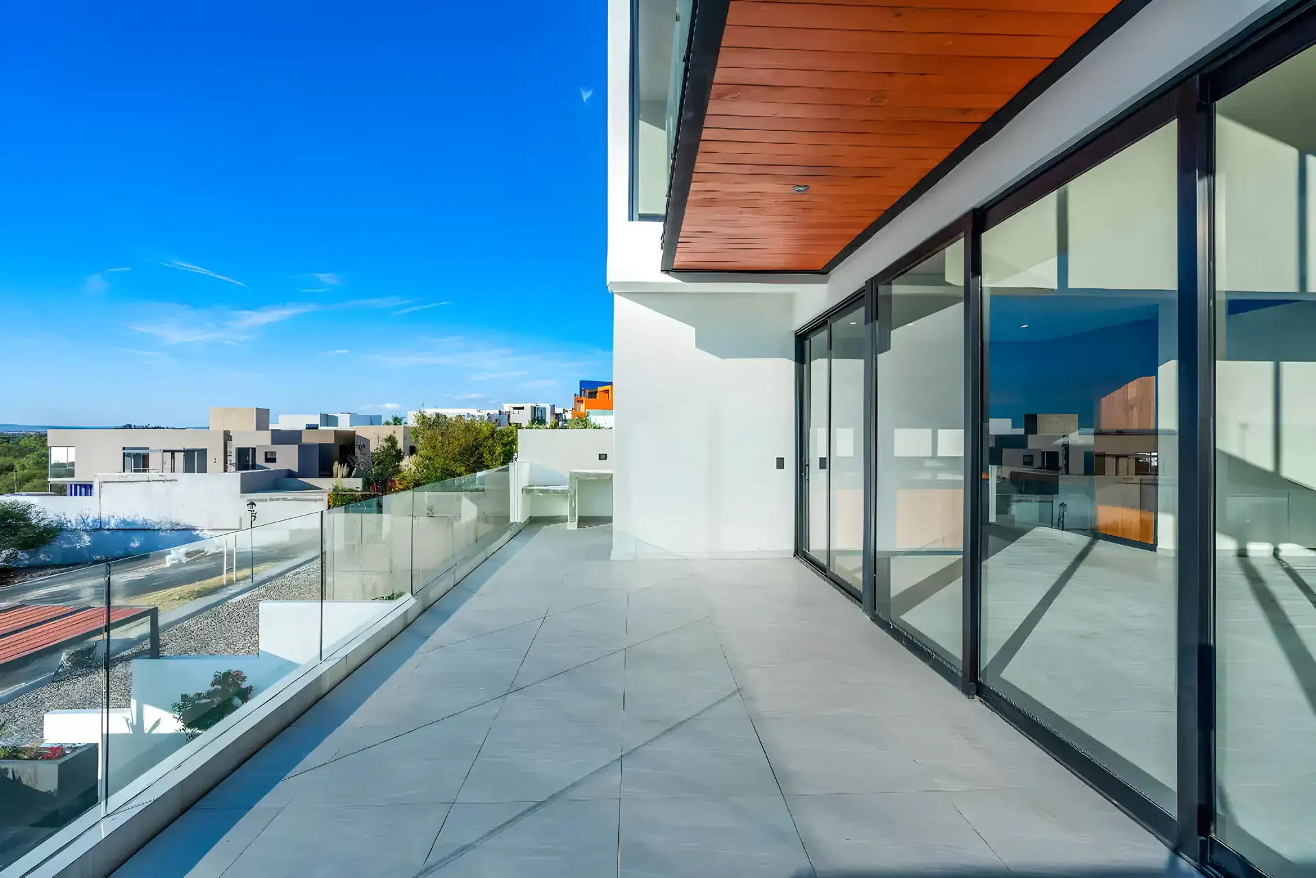 Casa de la Vista, glass-railed balcony with sliding glass doors overlooking the valley, San Miguel de Allende