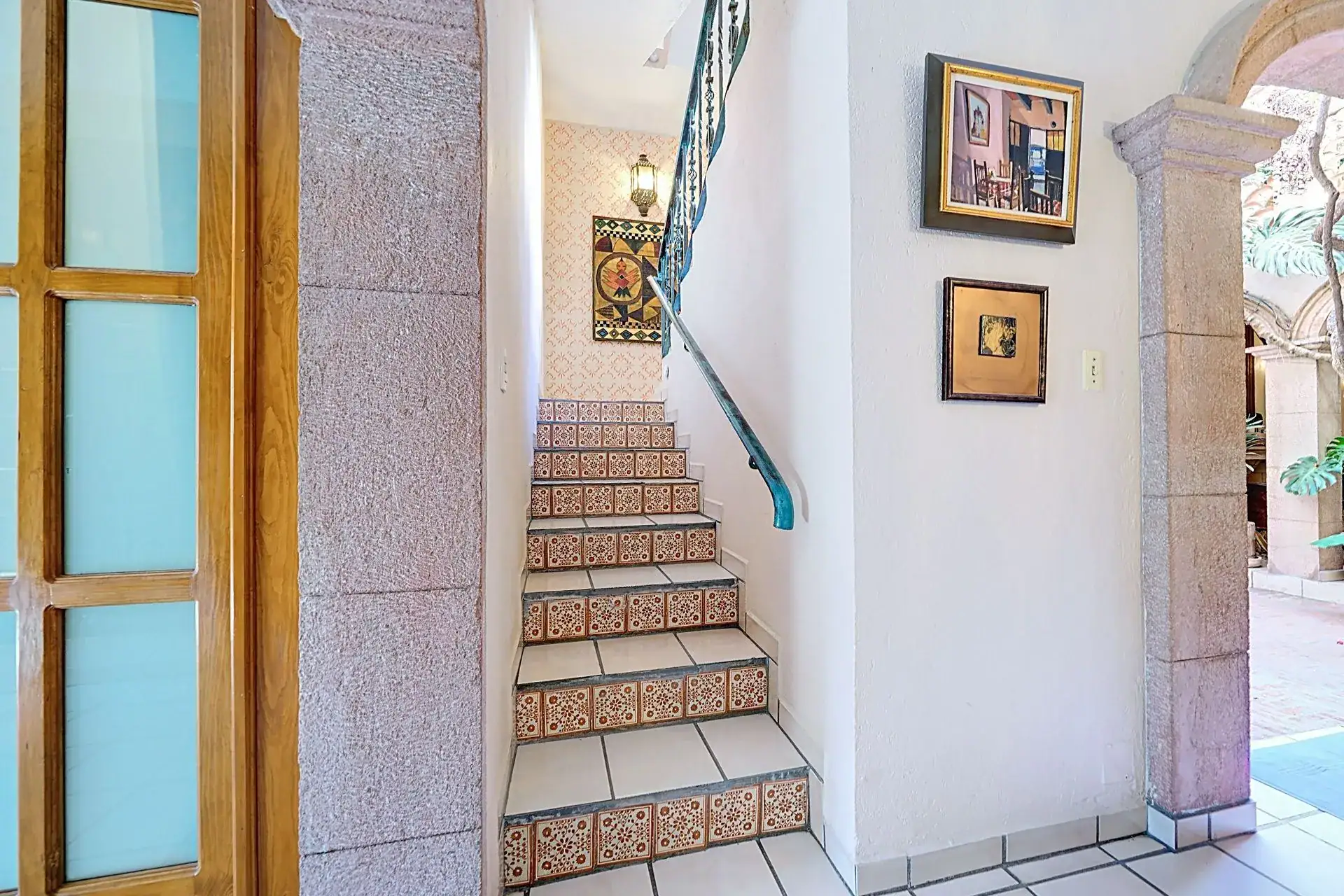 Casa de las Cruces, staircase with painted Talavera tile risers beside glass doors, San Miguel de Allende