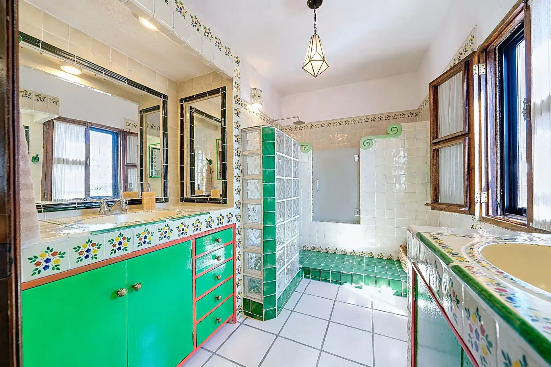 Casa de las Cruces, bathroom with a green vanity, glass block shower wall and tiled counters, San Miguel de Allende