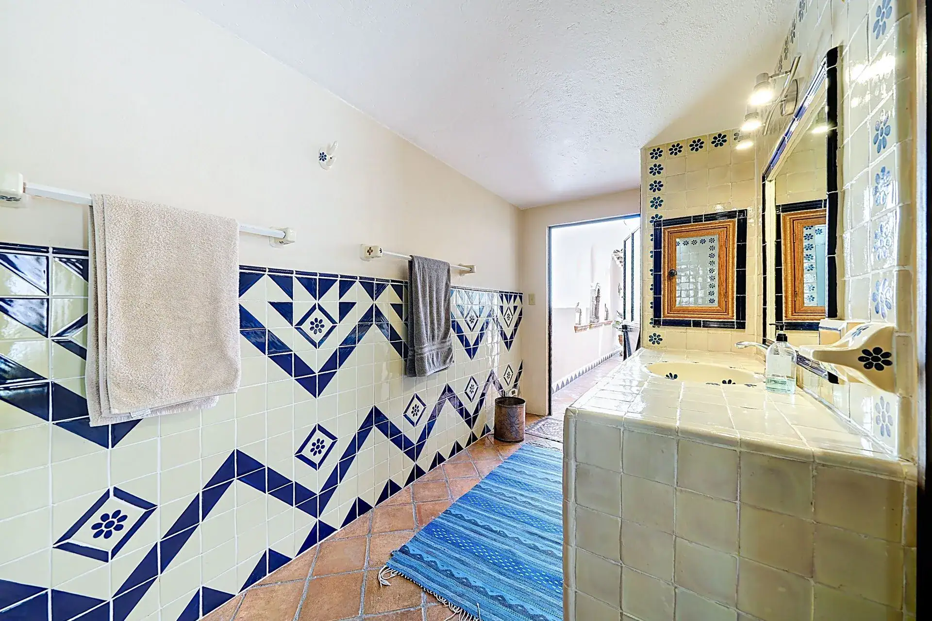 Casa de las Cruces, bathroom with a blue and white zigzag tile wall and a tiled counter, San Miguel de Allende