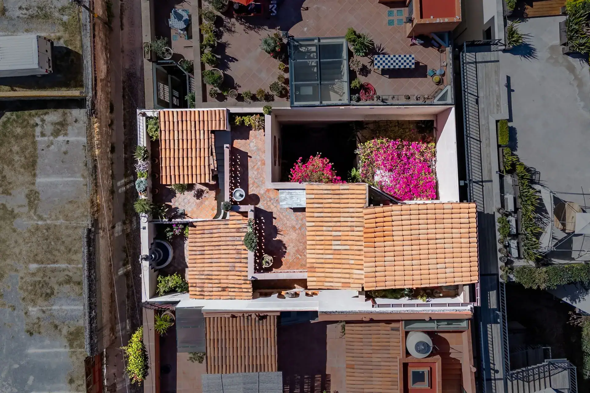 Casa de las Cruces, overhead drone view of the rooftop terraces and tiled roofs, San Miguel de Allende