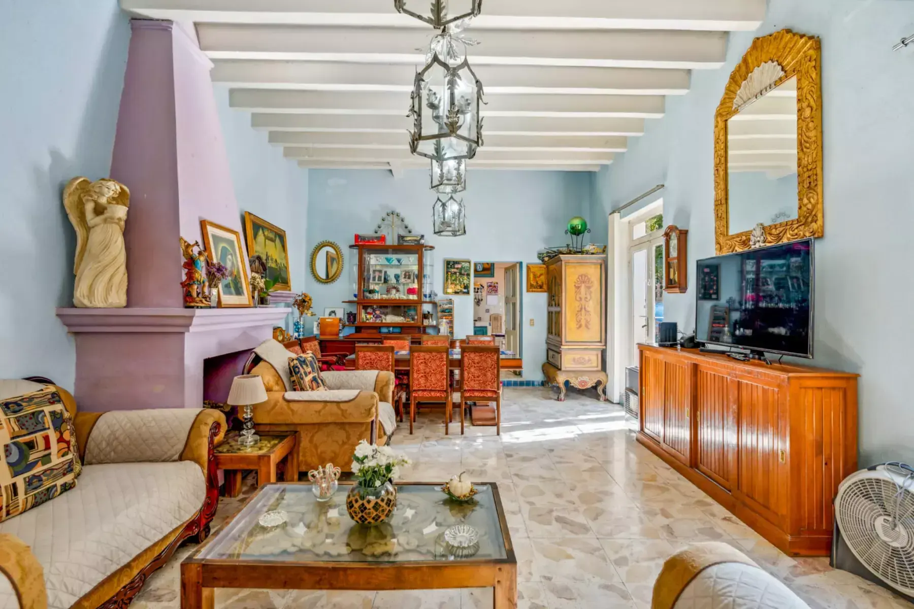 Casa de los Espejos, living and dining area with a gold mirror and a lantern pendant, San Miguel de Allende